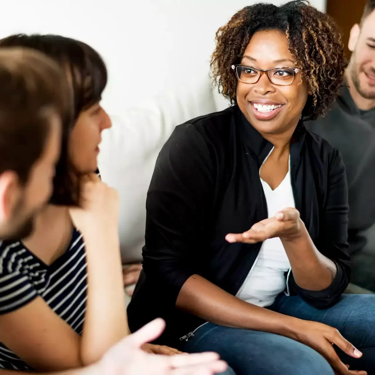 Social worker chatting with family on the sofa