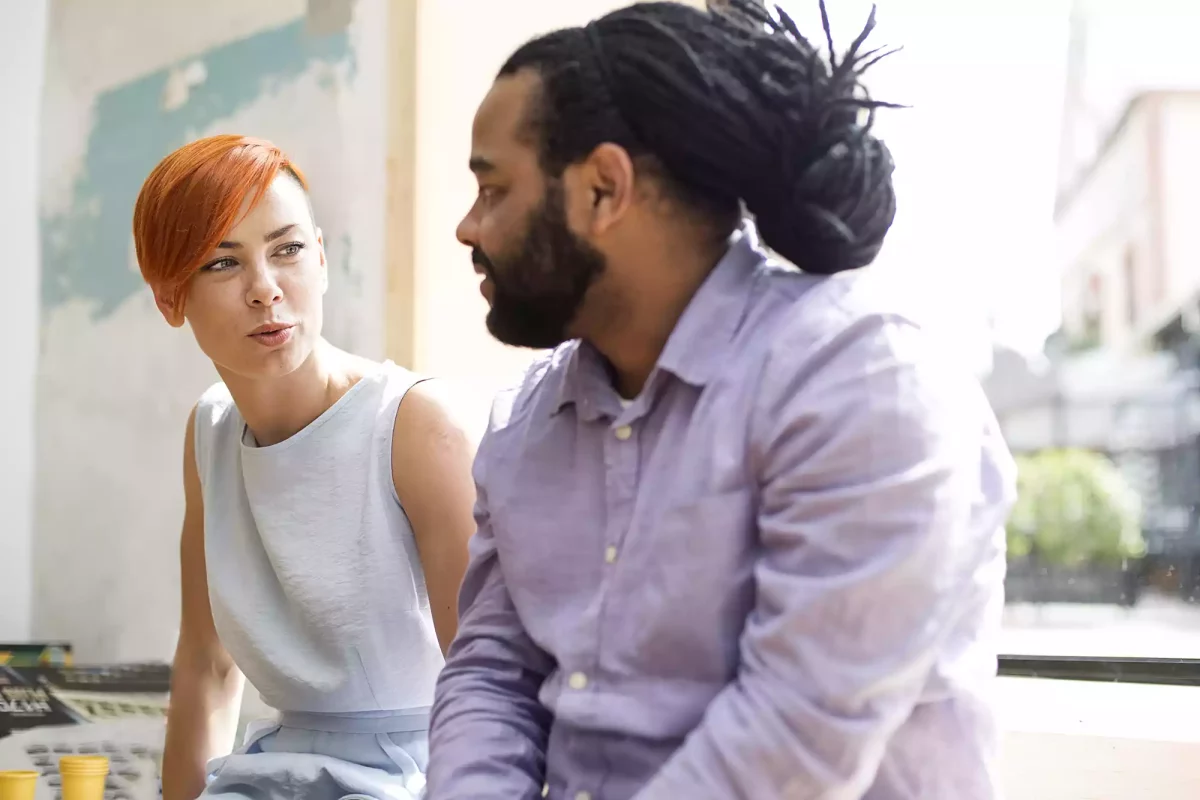 Male and female colleagues talking