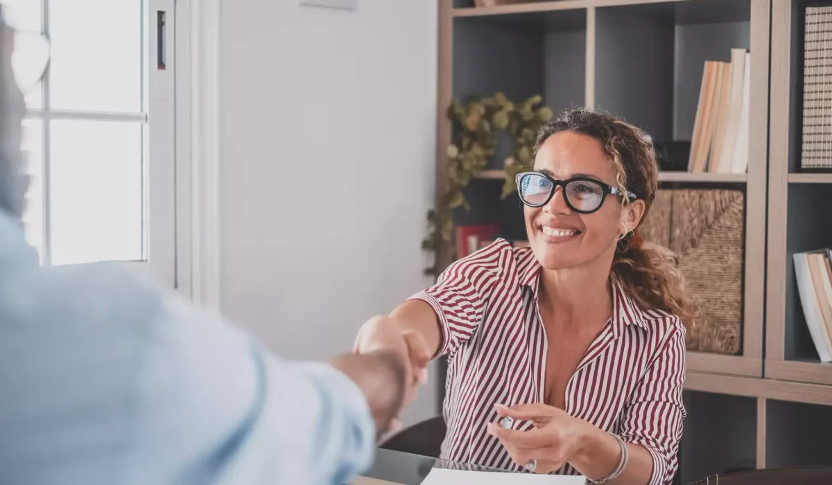 Woman shaking hands with a man